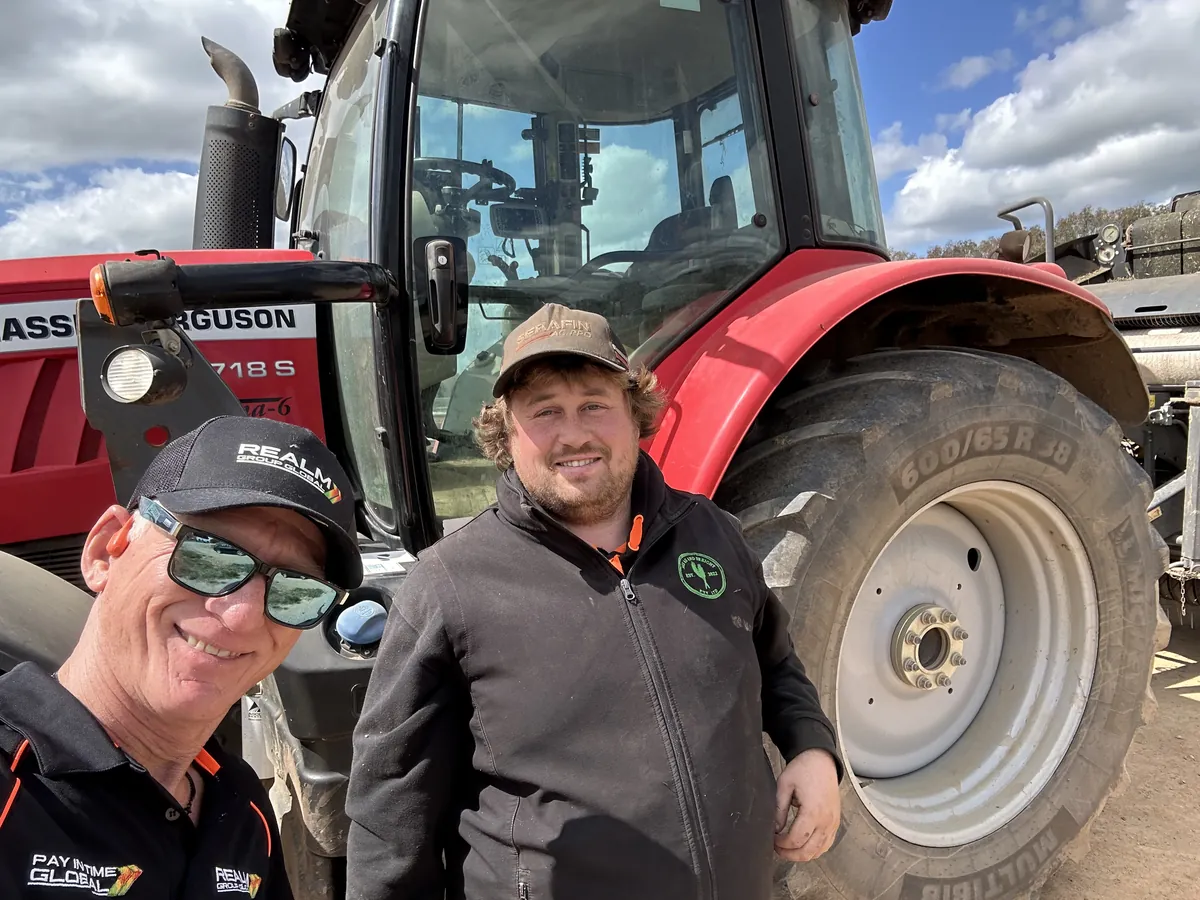 REALM team members in front of a tractor